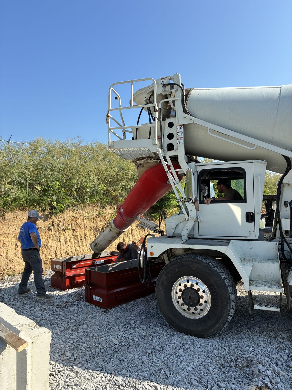 Kelley white mixer pouring concrete into forms